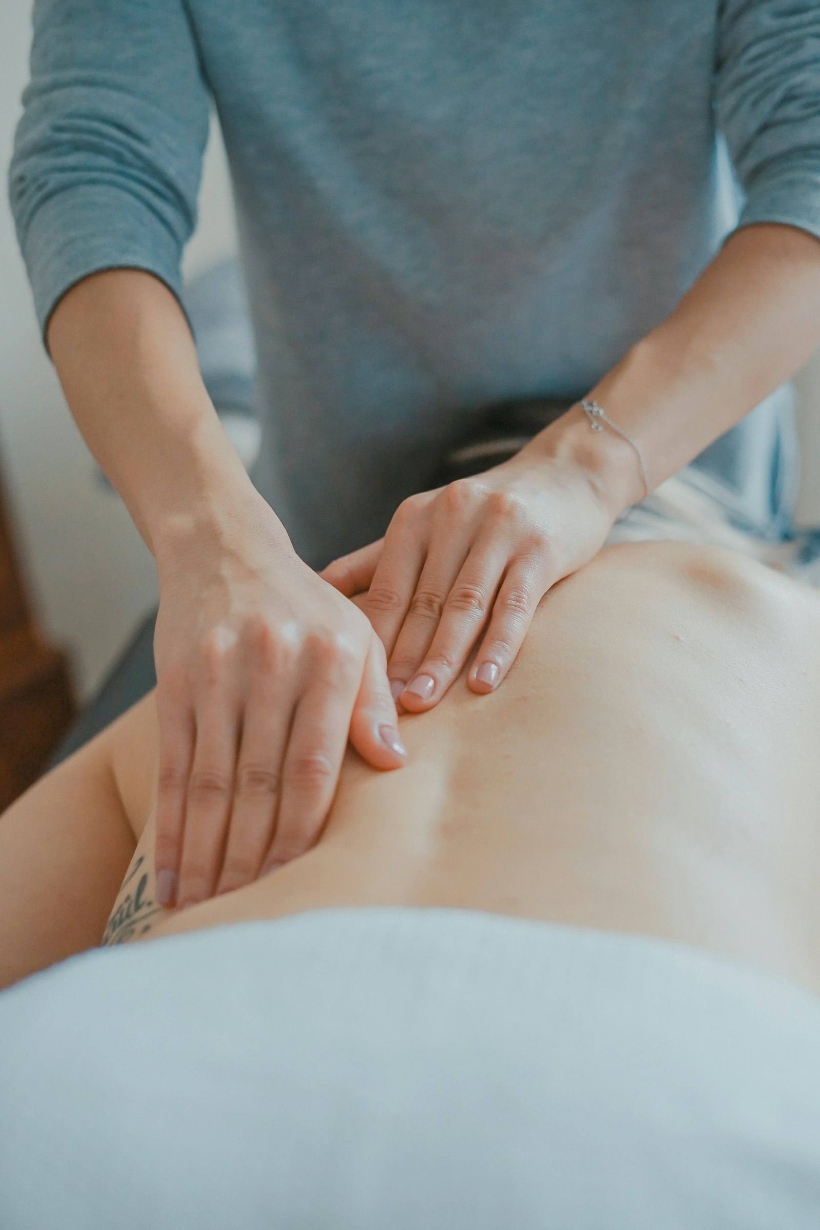 Therapist performing focused back massage