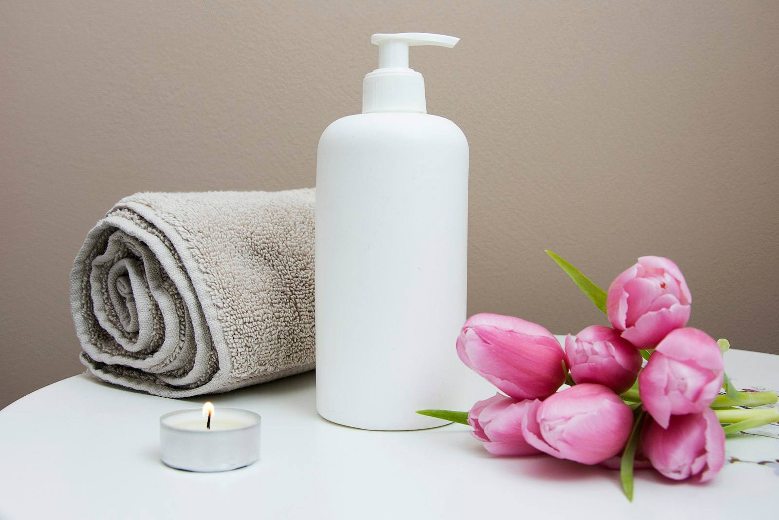 Fresh towels and massage oil prepared for a session