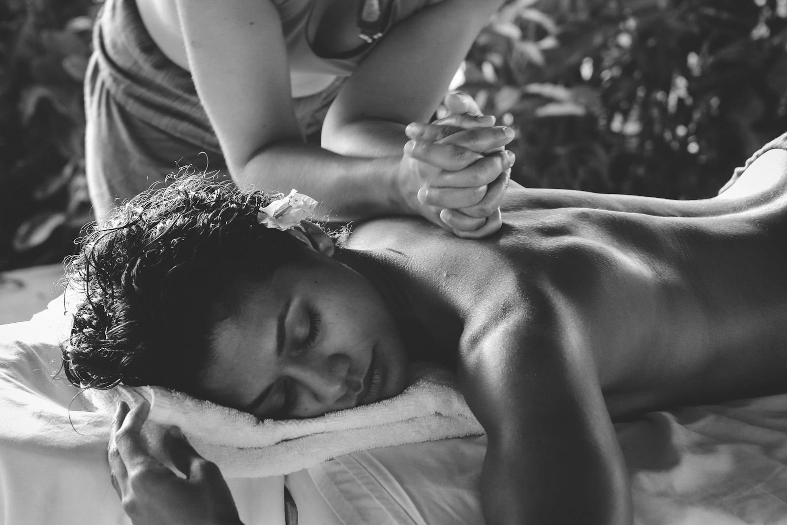 Therapist applying focused pressure to a client’s back